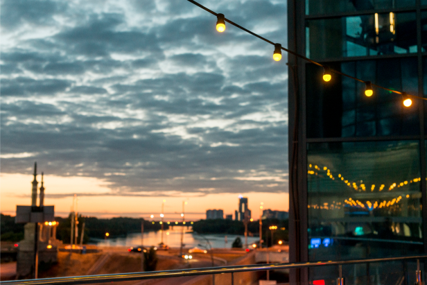 Sunset view over a city skyline with string lights